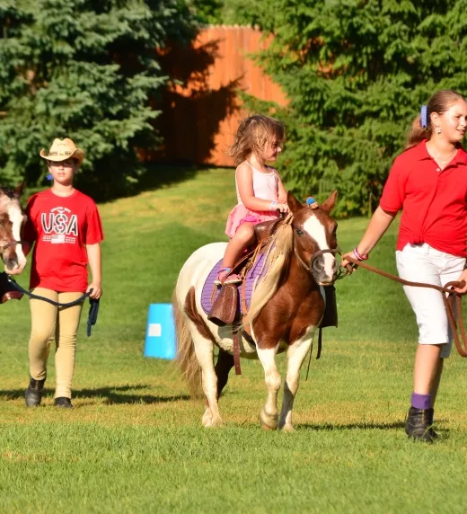 Group of children riding ponies.