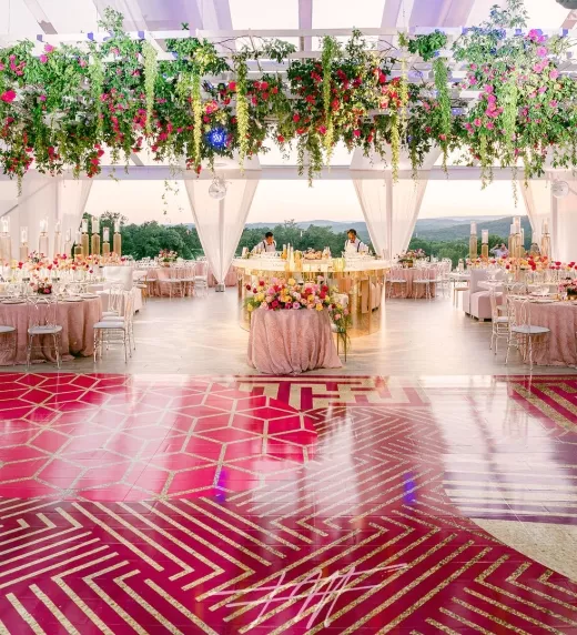 Wedding reception featuring pink dance floor and florals in Big Sky Pavillion.