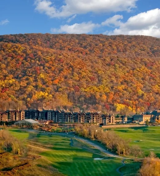View of fall mountains behind Grand Cascades Lodge at Crystal Springs Resort in NJ