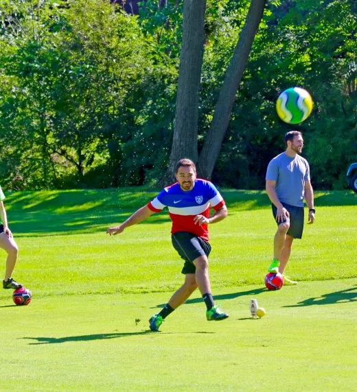 Group of friends playing foot golf on a golf course at Crystal Springs Resort