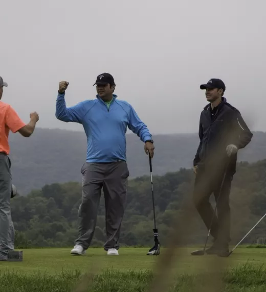 Four guys playing golf at a resort close to NYC