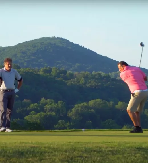 Two Golfers making their swings at a golf course near NYC