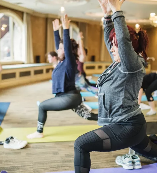Women in forward warrior yoga pose