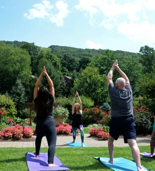  Outdoor Yoga Class surrounded by greenery