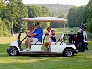 Parents with their kids on a family friendly golf course at Crystal Springs Resort in New Jersey.