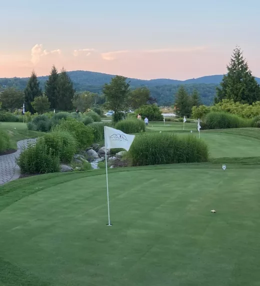 The putting green course at Grand Cascades Lodge at sunset