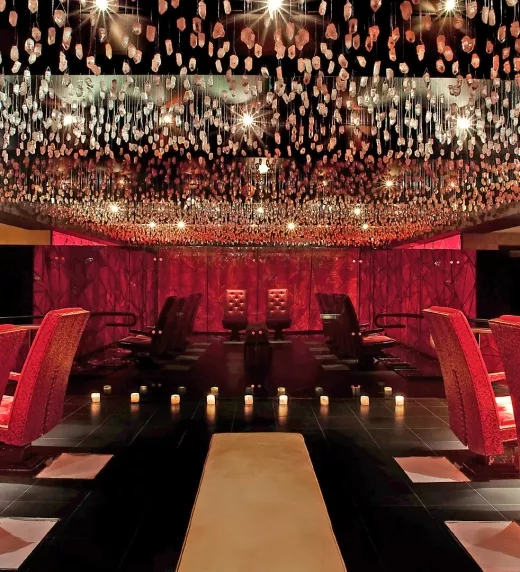 Crystal room at Reflections Spa featuring red chairs.