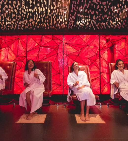 Group of women laughing in Reflections Spa foot scrub room.