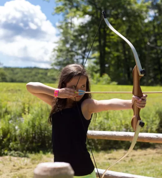 Young girl doing archery.