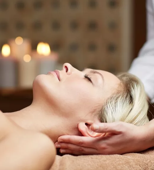Blonde haired woman laying on spa table.