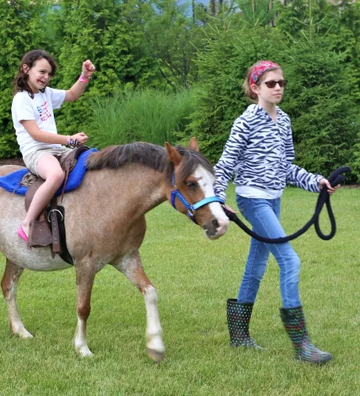 Young Girl Riding a Pony