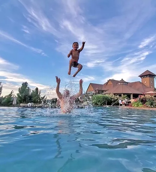 Man throwing child in air in vista 180 pool.