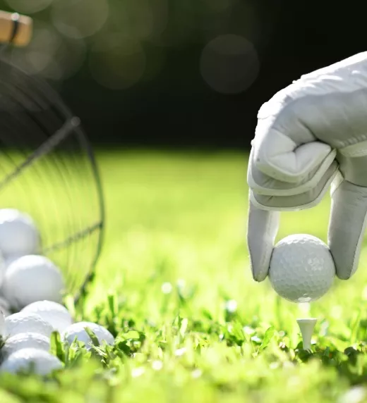 Hand teeing up a golf ball