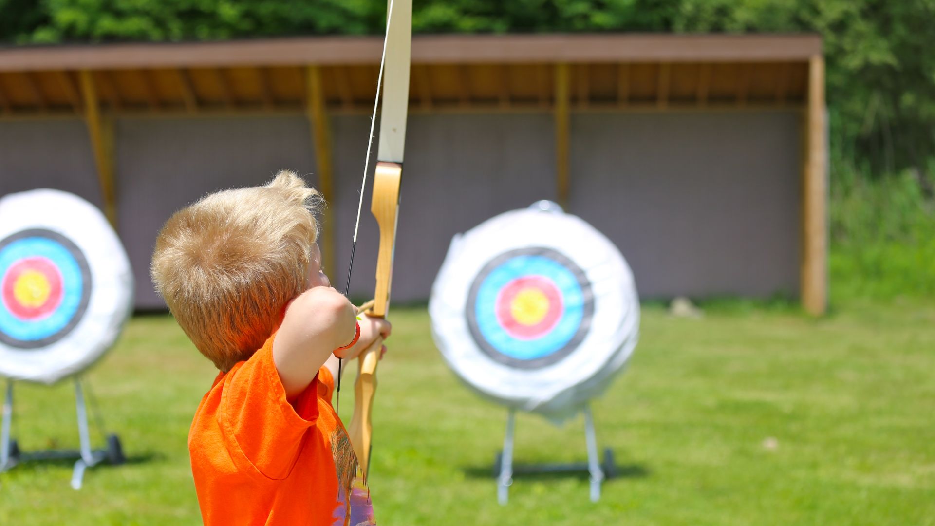 Boy doing archery target practice 