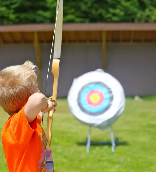Boy doing archery target practice 