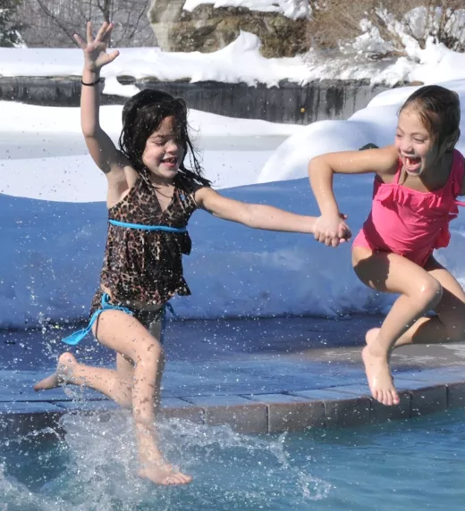 Young girls jumping into the snow pool at Minerals Hotel