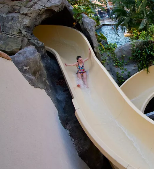 Young girl going down the Biosphere water slide