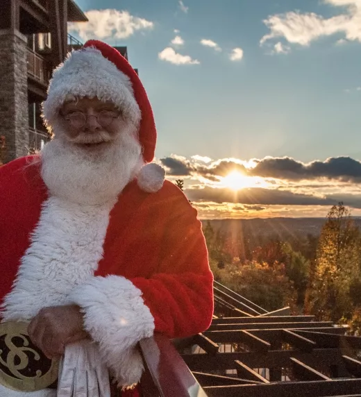 Santa in front of scenic view at Grand Cascades Lodge at Crystal Springs Resort NJ