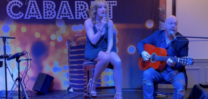 A couple singing at a show at Crystals Springs Resort
