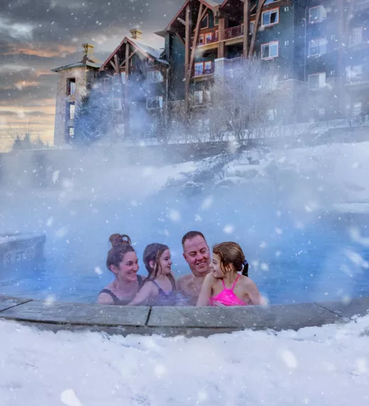 Family enjoying snow pool at Grand Cascades Lodge