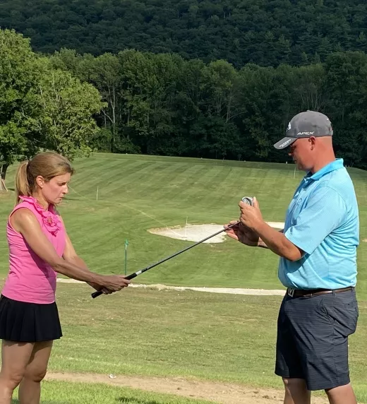 Golf Instructor with Leadbetter Golf Academy teaching woman to golf