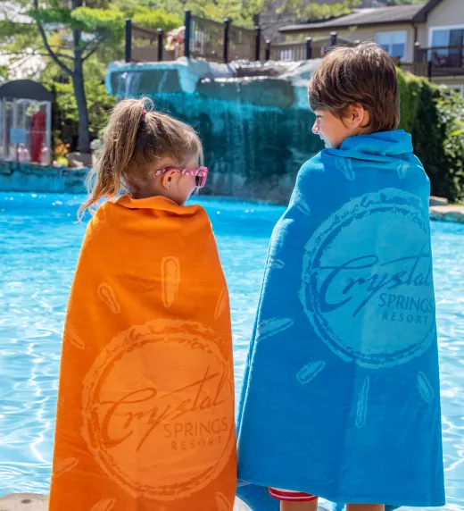 Children wrapped in Crystal Springs Resort towels at the pool