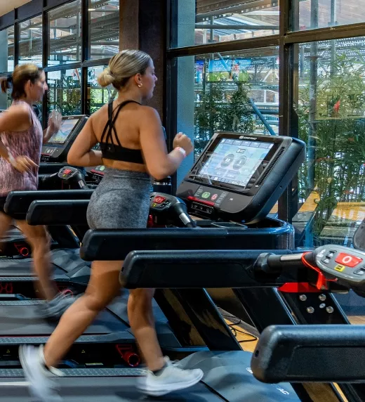 Women running on treadmills.