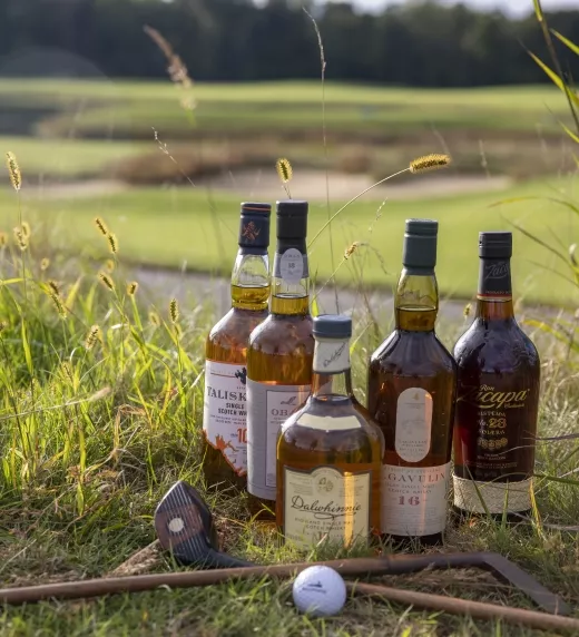 Bottles of whiskey set up with old style clubs