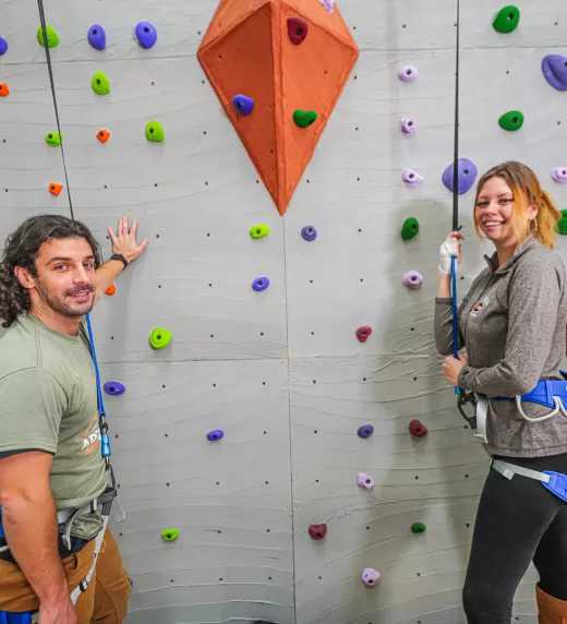 Two adults getting ready to rock climb.
