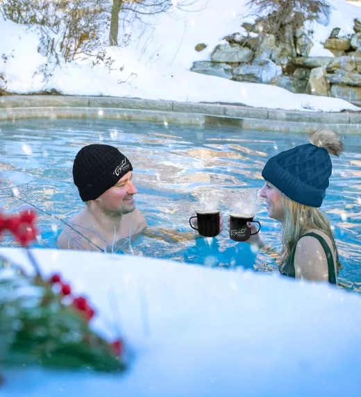 Couple enjoying drinks in the snow pool