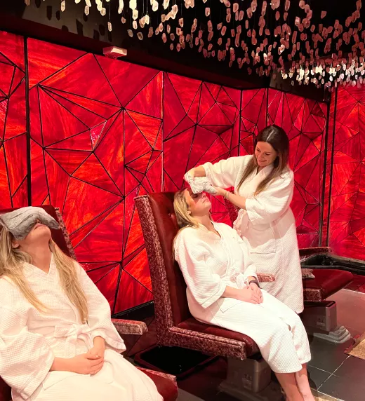 Two women getting heated facial towels at Reflections Spa