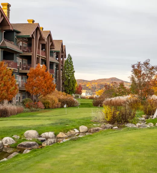Grand Cascades Lodge in Fall with mountains in back.