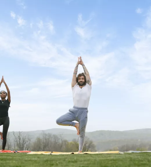 Three people in yoga pose.